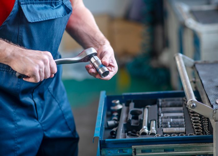 young-adult-confident-man-work-uniform-working-cars